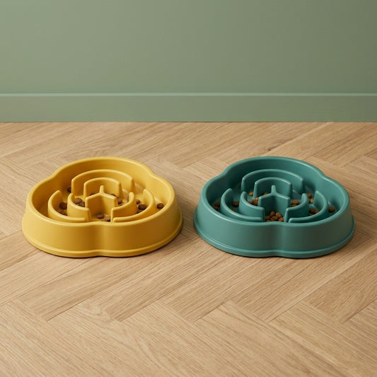 Gamelle anti-glouton pour chien en labyrinthe, coloris jaune et vert, posées sur un parquet